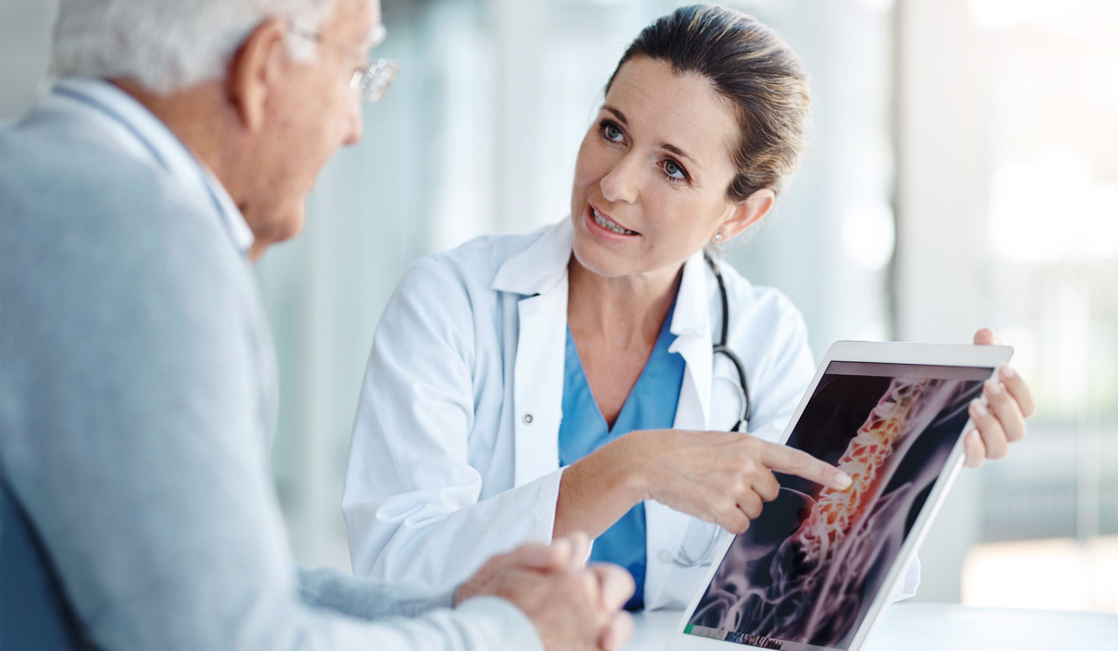 GettyImages-1147479221_cropped Doctor discussing spine scan with patient